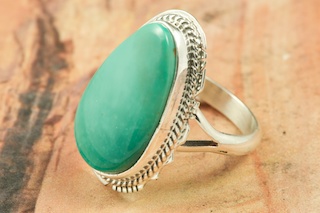 Genuine Manassa Turquoise set in Sterling Silver Ring. This Turquoise is also referred to as King�s Manassa Turquoise. The Manassa Turquoise mine is located in Manassa, Conejos County, Colorado. Created by Navajo Artist Larson Lee. Signed by the artist.